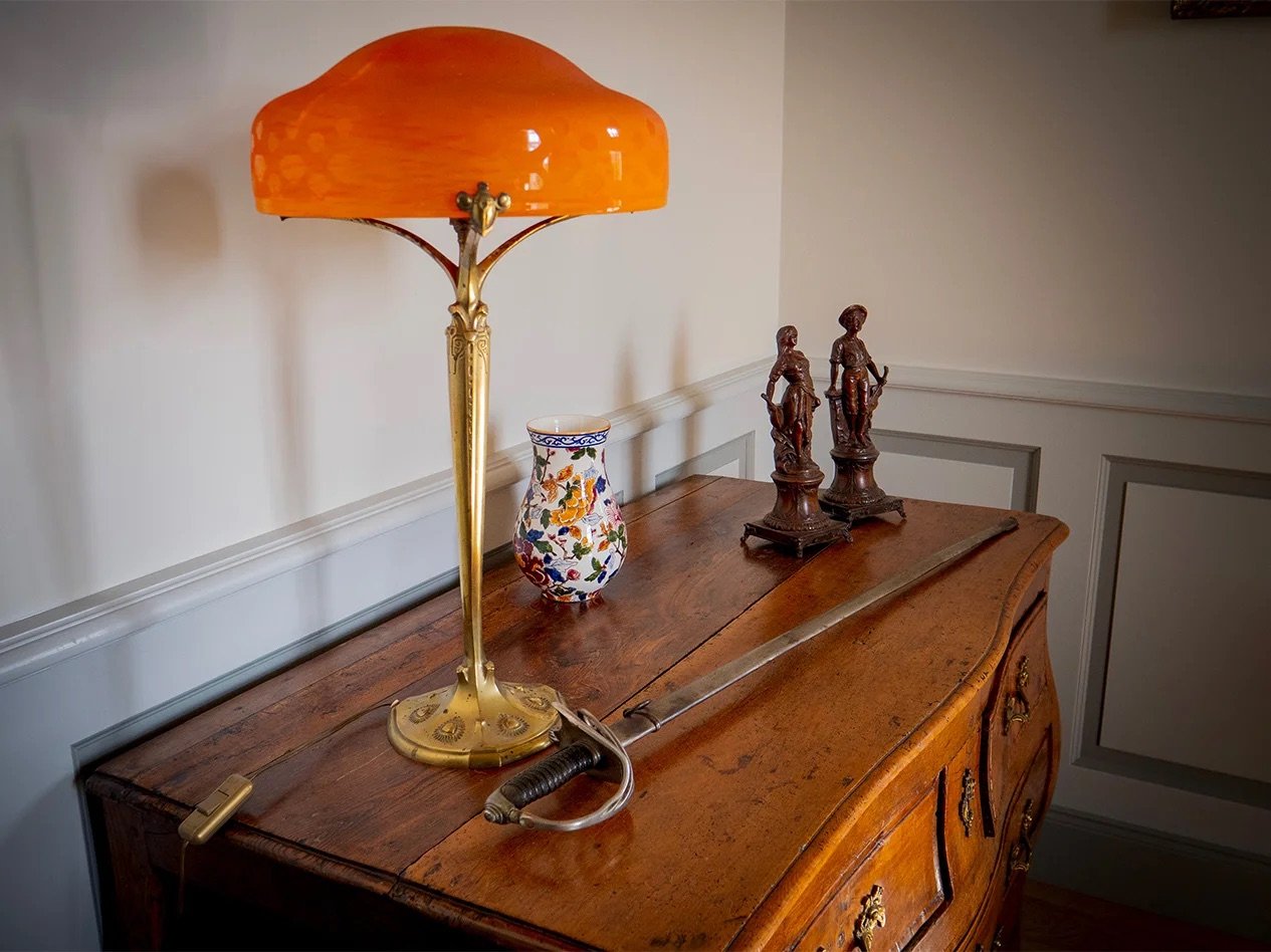 Art Nouveau lamp on a period chest of drawers